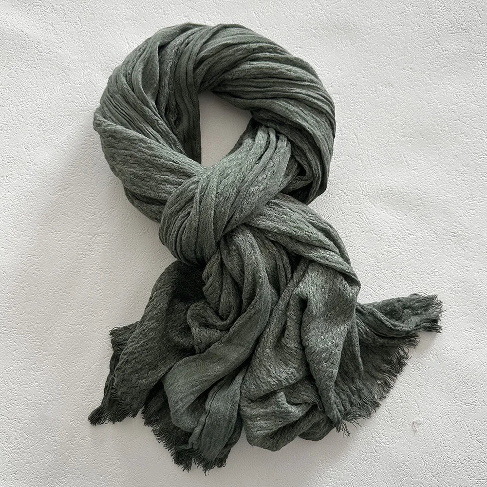 Women's long loose linen blend scarf with crinkled texture and frayed edges for effortless fall style