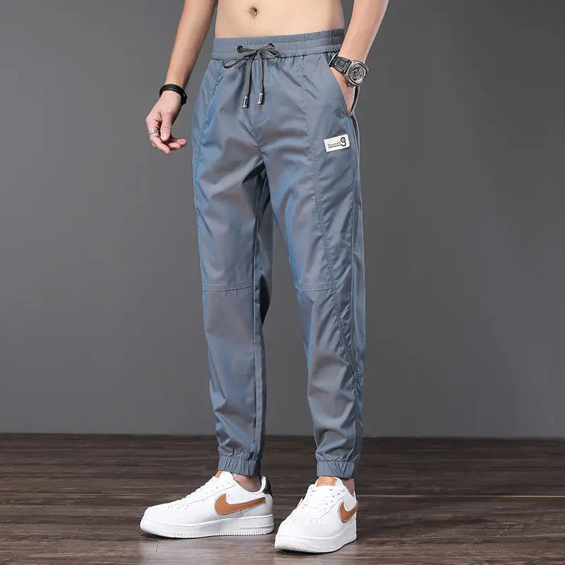 Unisex tapered nylon jogger with shiny light-shifting gradient, lightweight breathable slim fit