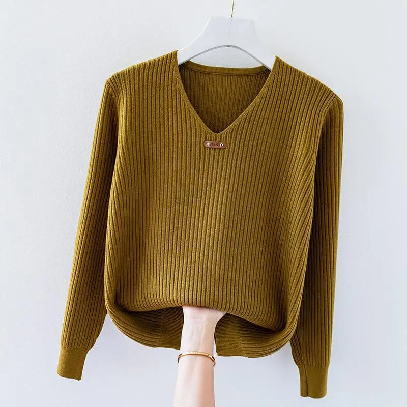 Women's slim-fit ribbed knit V-neck top in lightweight stretch fabric with subtle collar charm