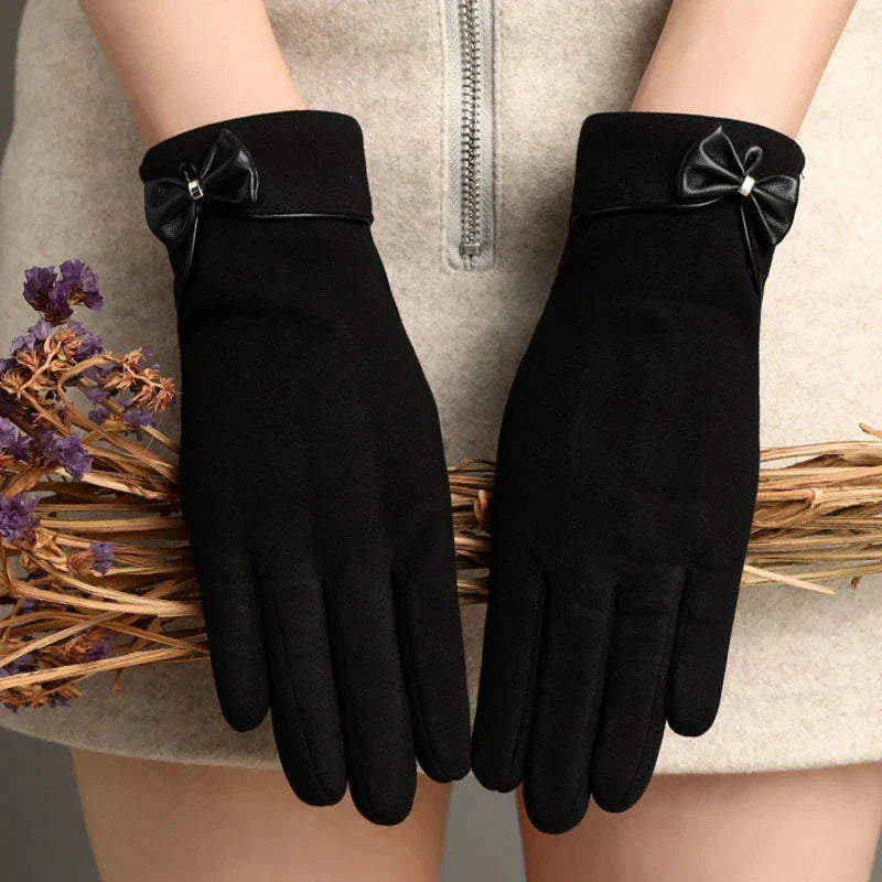Women's fitted wool wrist-length gloves in classic tone with feminine bow detail accent