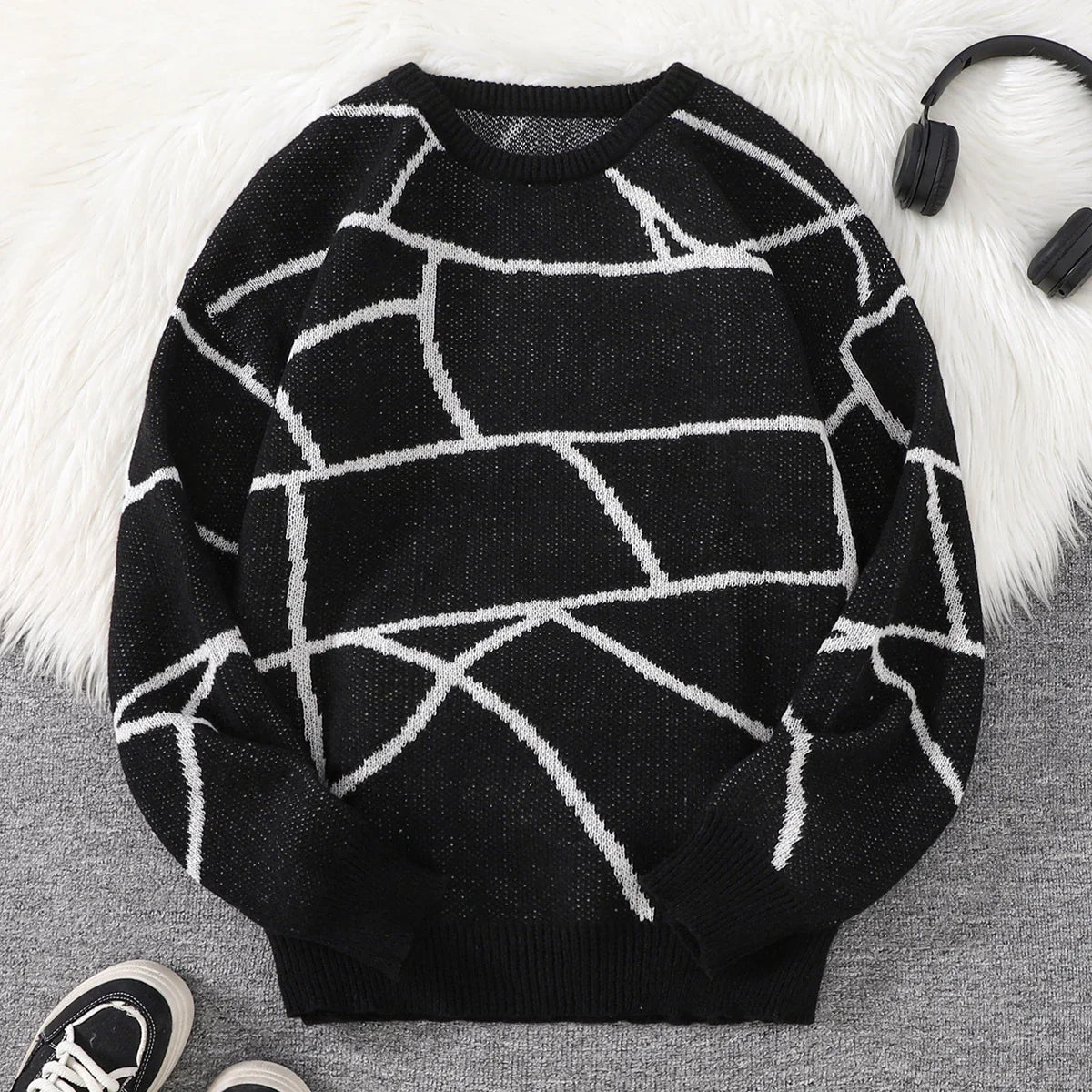 Black and white unisex geometric pattern sweater with relaxed fit and bold abstract urban motif