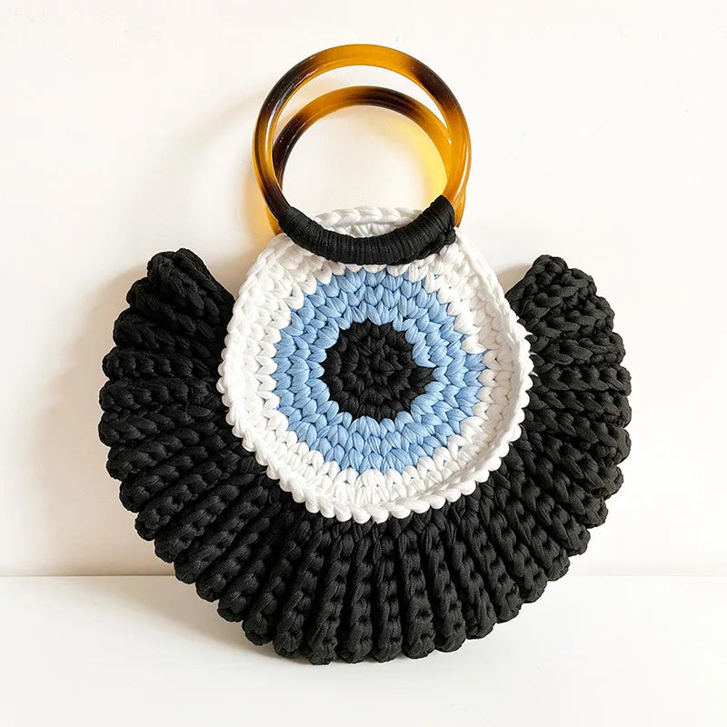 Handwoven evil eye mini clutch bag in blue talisman motif, compact everyday and evening accessory