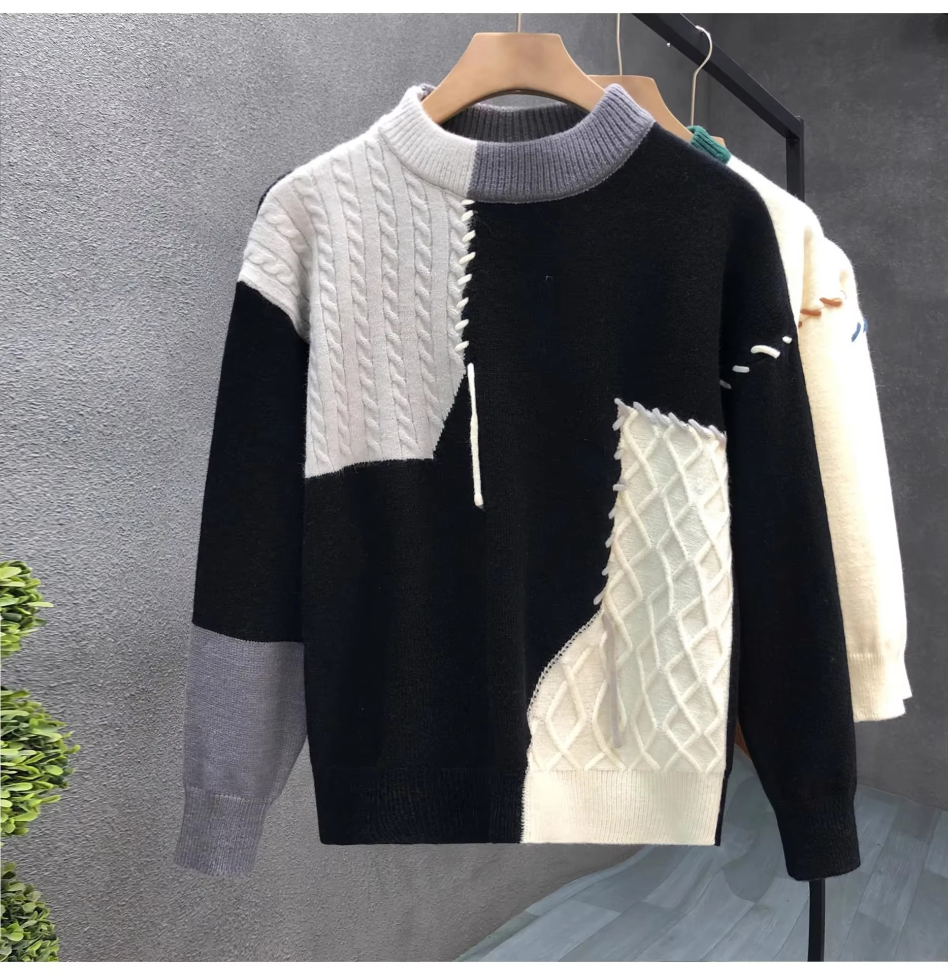 Men's patchwork knit sweater in color-blocked panels with textured streetwear pullover design for fall