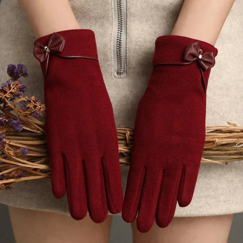 Women's fitted wool wrist-length gloves in classic tones with elegant bow detail accent