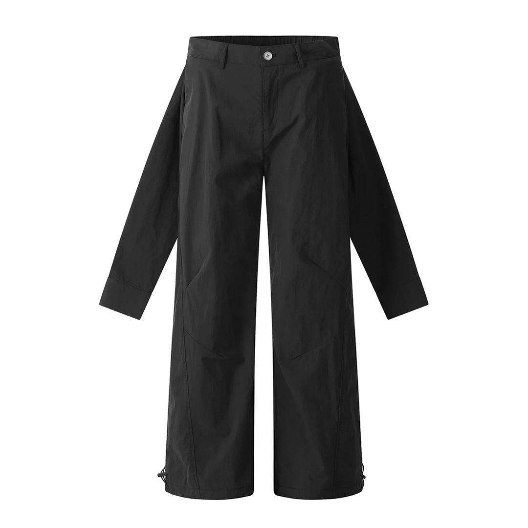 Black minimalist trousers with hanging sleeve waist detail, loose straight-leg cut, layered avant-garde silhouette