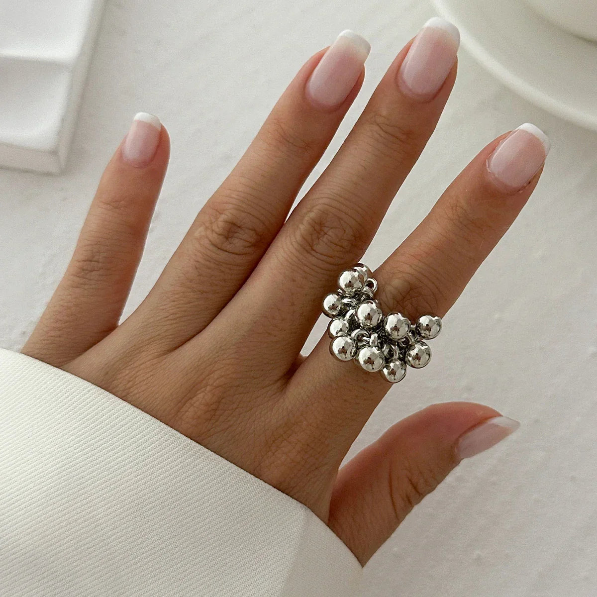 Adjustable open band statement ring with jiggling ball charm, bold kinetic jewelry for women