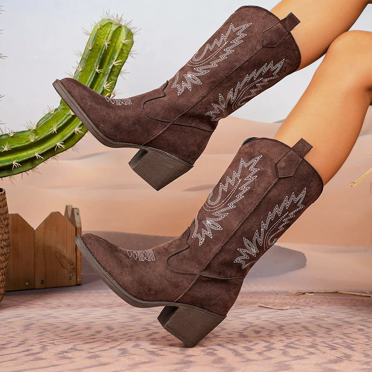 Women's brown leather knee-high boots with Western stitching details and a comfortable mid-heel