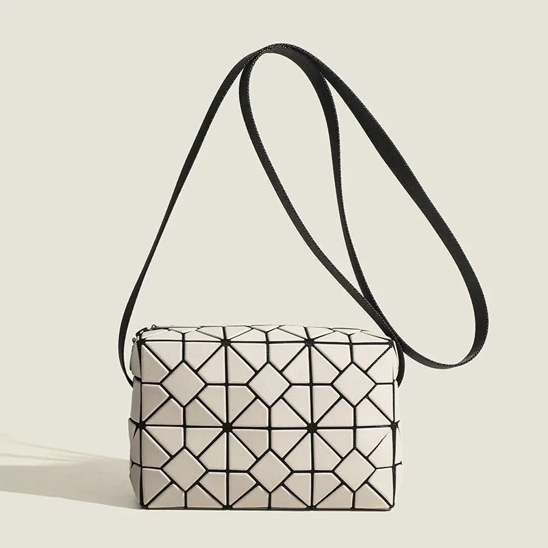Matte black geometric shoulder bag with bold sculptural silhouette and zip closure for daily commute