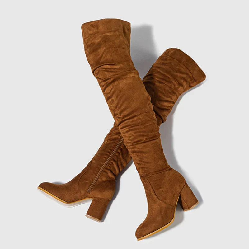 Women's black over-the-knee heeled boots with sleek stiletto heel and leg-elongating silhouette