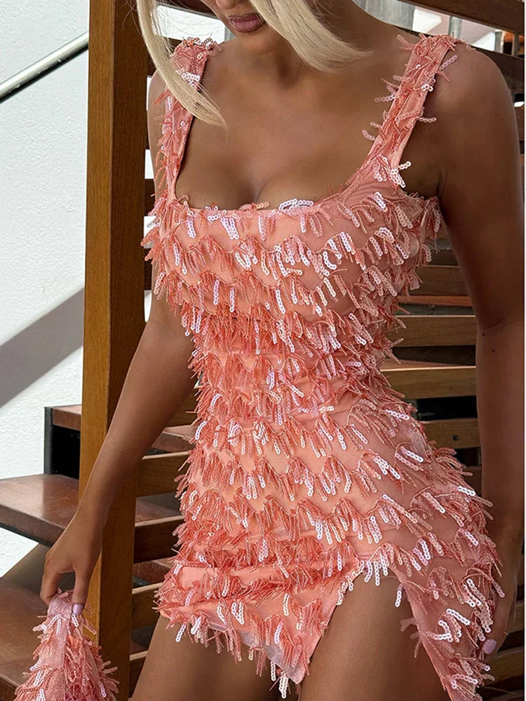 Black cocktail dress with feather fringe hem and subtle sequin detailing for glamorous evenings