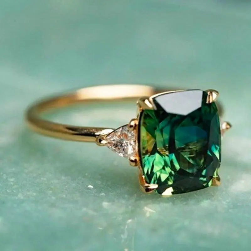 Melissa emerald statement ring gold band cushion-cut emerald-green gemstone bold sparkle
