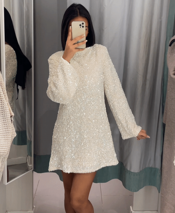 Women's silver sequined long sleeve mini dress with open back bow detail for party evening wear