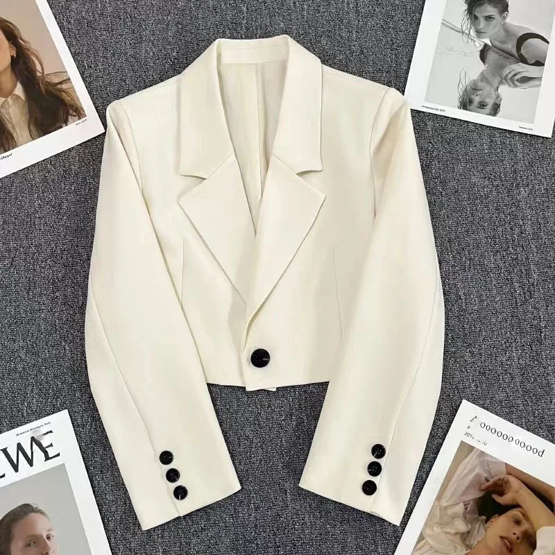 Black cropped women's blazer with notched collar, modern sharp silhouette for workwear and casual outfits