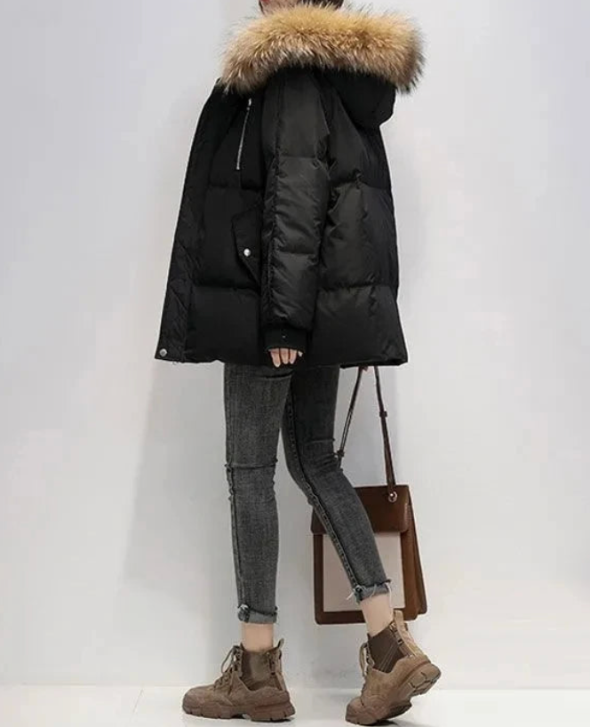 Women's winter coat with faux fur hood, structured silhouette, sleek non-bulky cold-weather outerwear