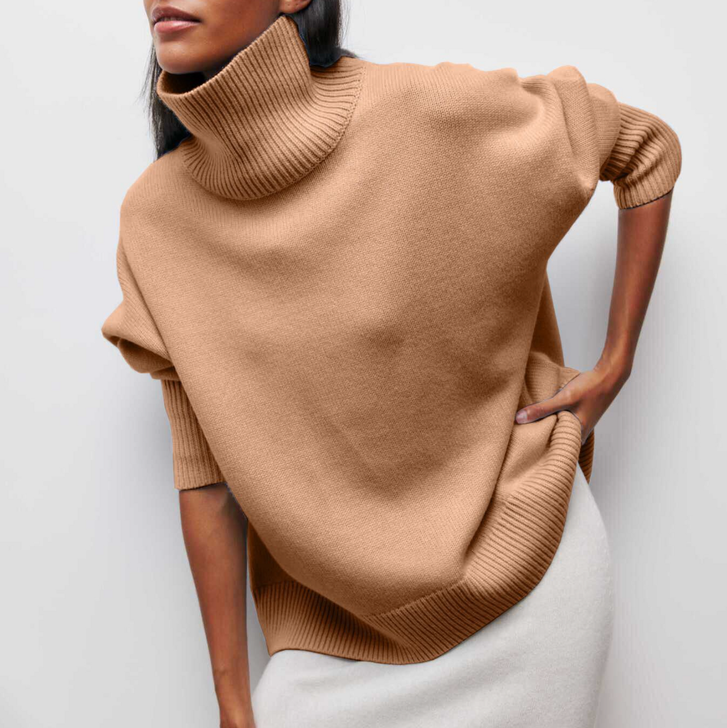 Women's oversized turtleneck knit sweater with draped silhouette and ribbed cuffs for layering
