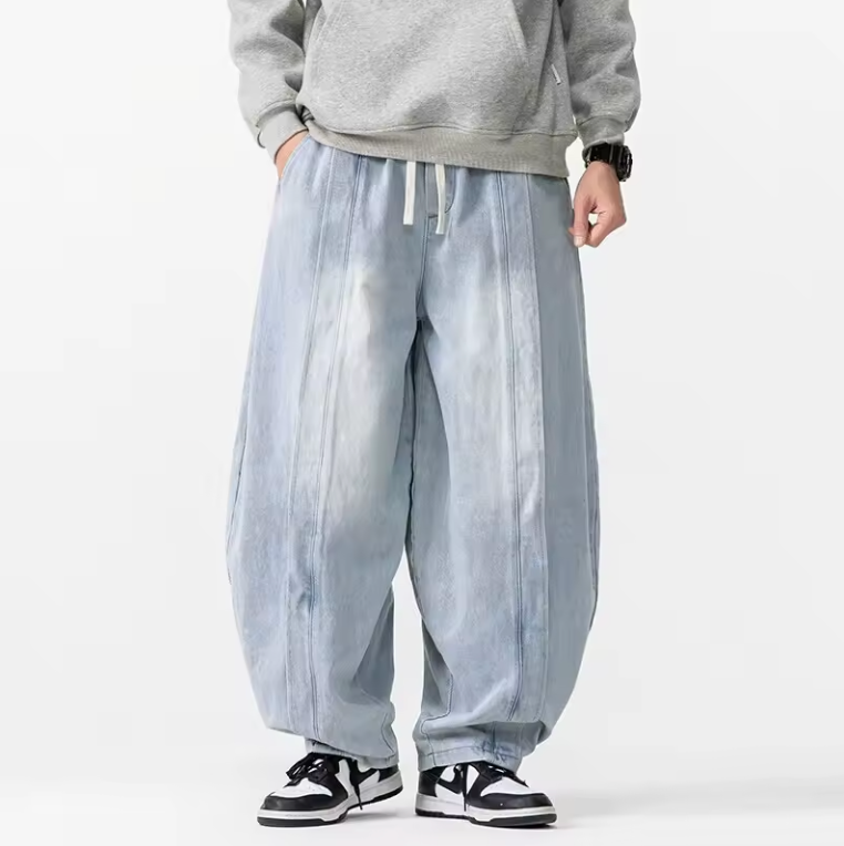 Men's wide leg relaxed fit denim pants in premium blue with harem-inspired structured drape