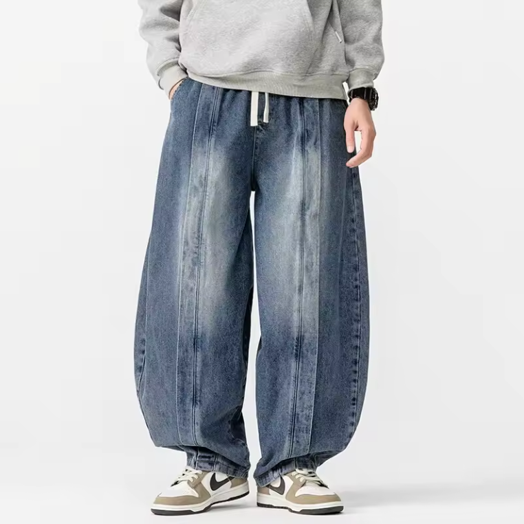 Men's wide leg relaxed fit denim pants in premium blue with harem-inspired structured drape