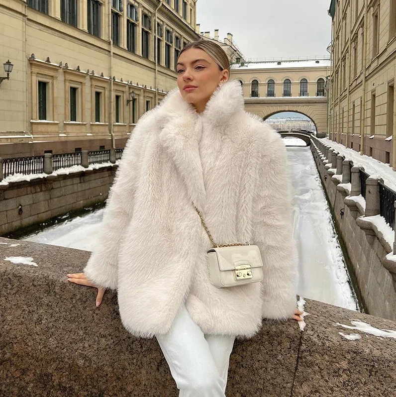 Women's plush faux fur luxury jacket in soft neutral tone, polished silhouette for chic winter warmth