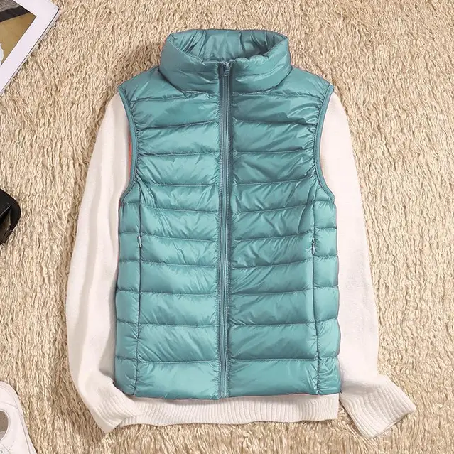 Women's ultralight packable down jacket in neutral tone, sleek slim fit with sustainable insulation