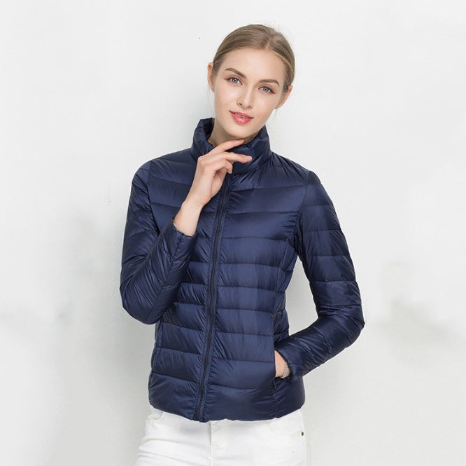 Women's black quilted slim-fit insulated jacket with zip front and high collar for transitional weather