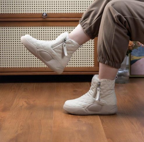 Women's waterproof snow boots in neutral tones, rugged outdoor silhouette with insulated cold-weather sole
