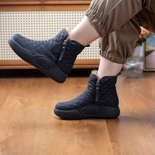 Women's waterproof snow boots in neutral tone, rugged outdoor winter silhouette with insulated warm lining