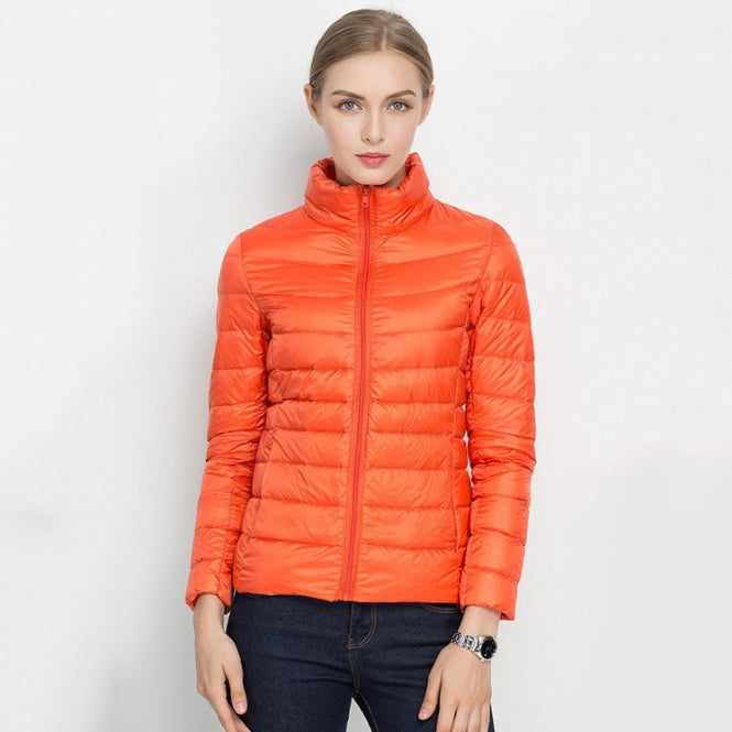 Women's black quilted slim-fit jacket with zip front and high collar, lightweight insulated transitional outerwear