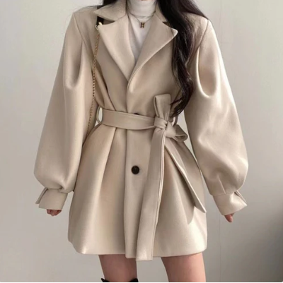 Women's tailored wool lace coat in neutral tones with elegant lace detailing and defined structured edges