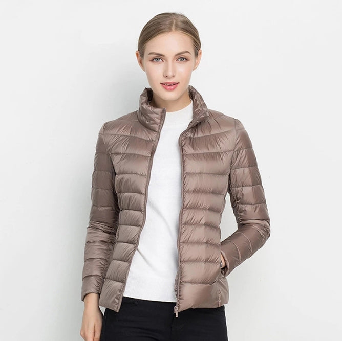 Women's slim-fit quilted jacket with high collar, zip front, insulated for transitional weather