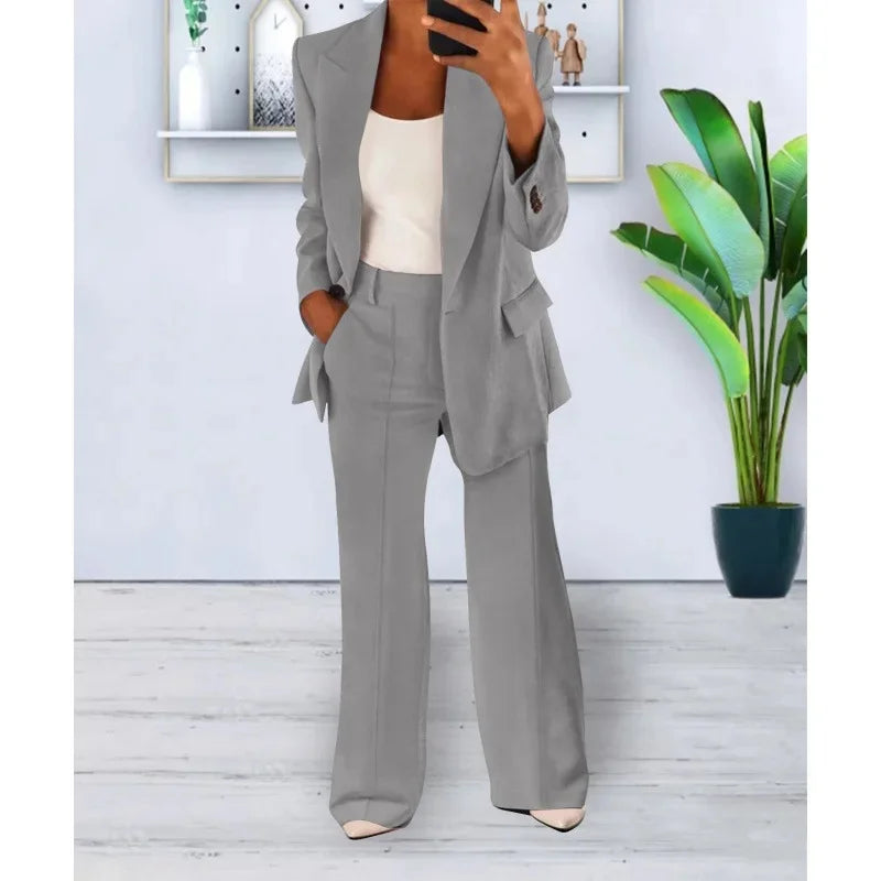 Women's black tailored long blazer suit set with straight-leg trousers and refined lapel