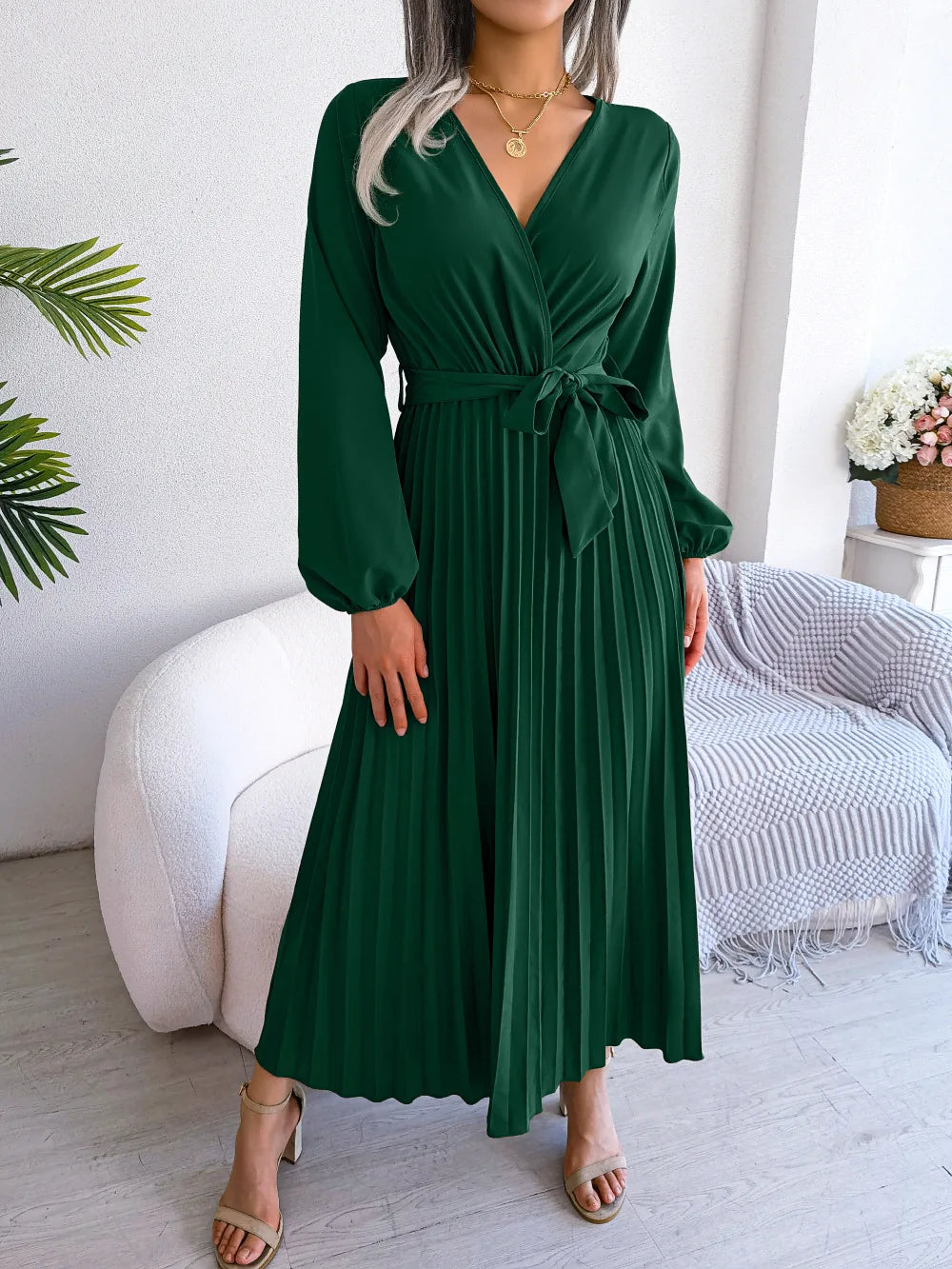 Women's flowing maxi dress with deep V-neck, soft pleats, long sleeves, relaxed silhouette