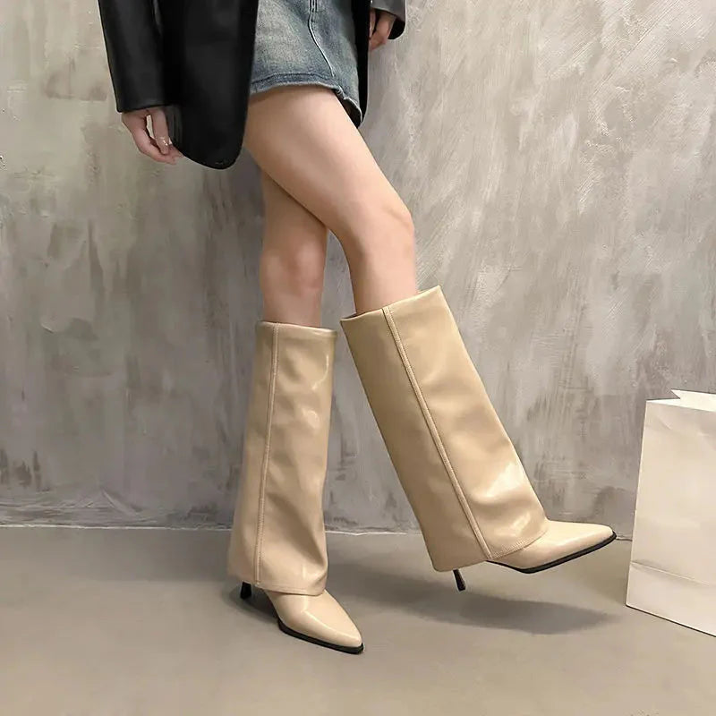 Women's black leather thigh-high boots with small heel and elegant buckle accent detail