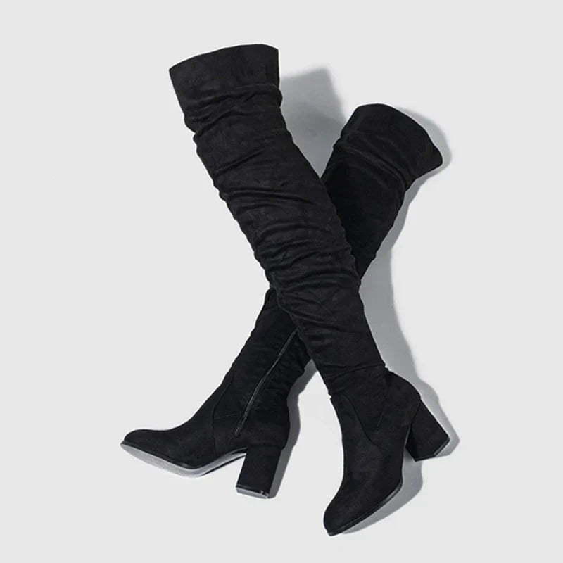 Women's black over-the-knee heeled boots with sleek silhouette and leg-elongating stiletto heel