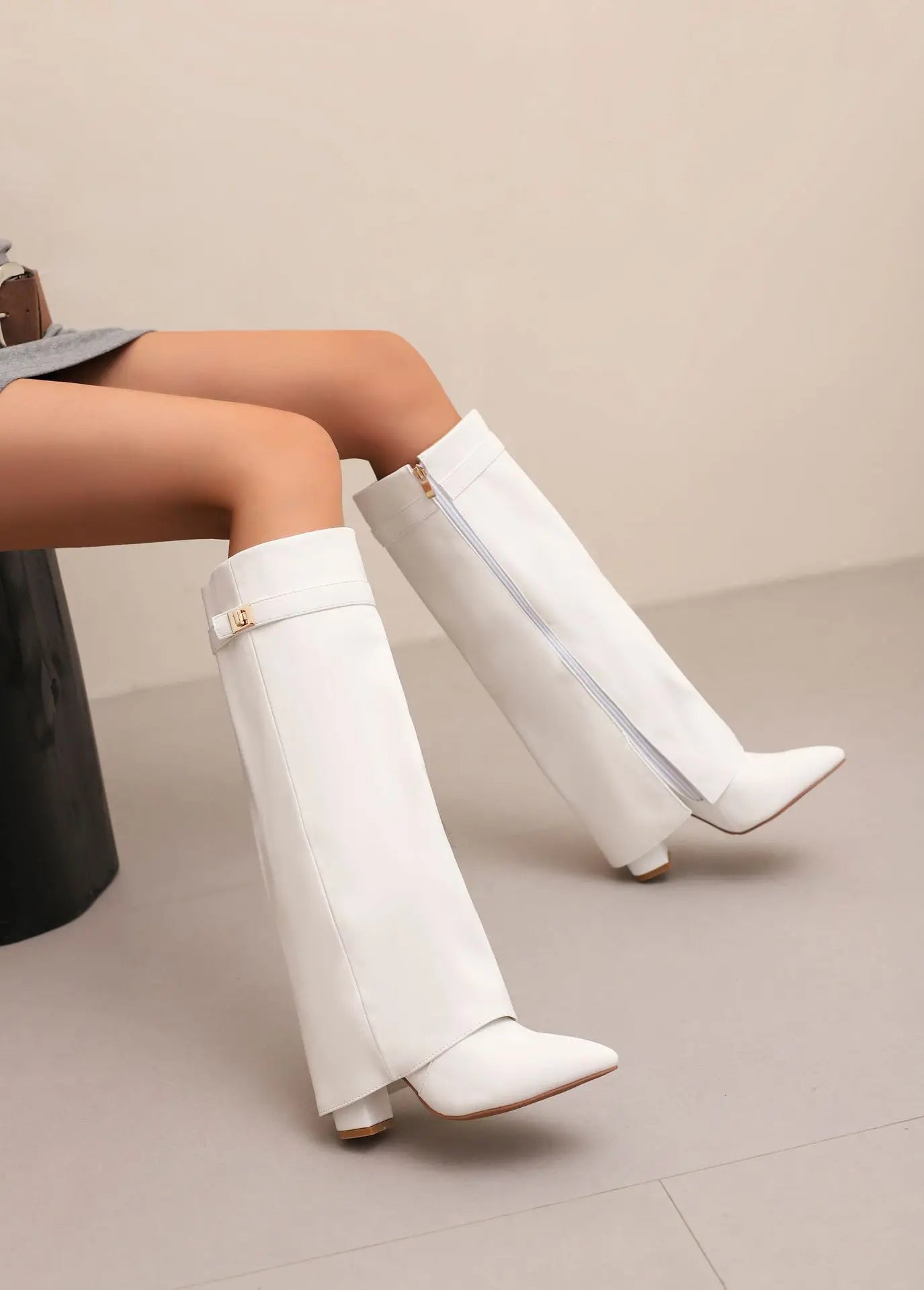Black leather thigh-high boots with buckle detail, elegant slim silhouette for women