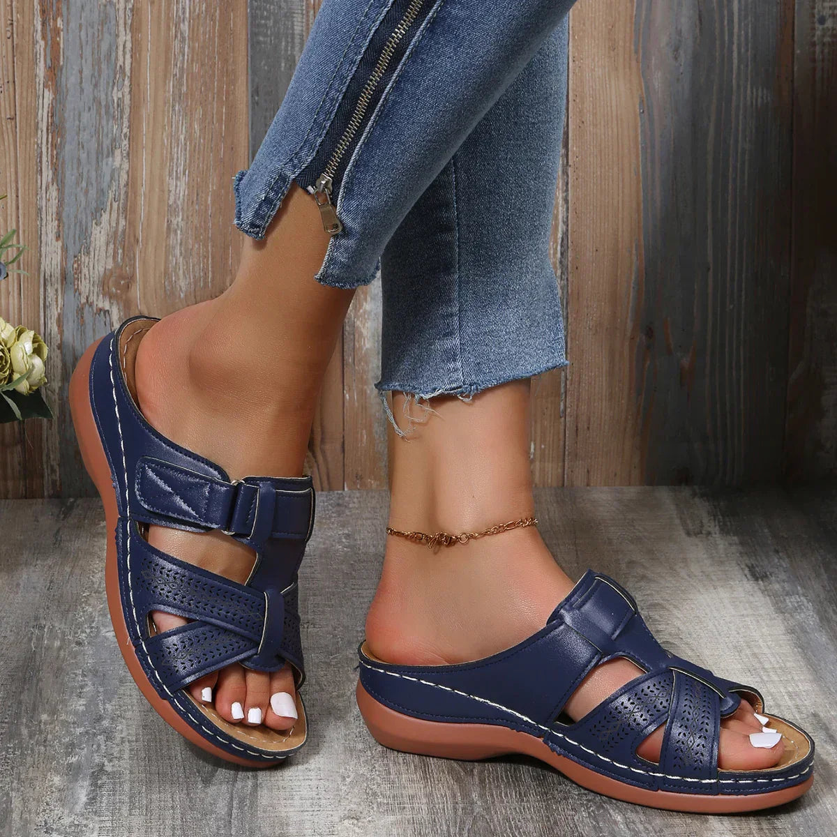 Women's beige openwork slide sandals with criss-cross velcro straps and cushioned insole for comfort