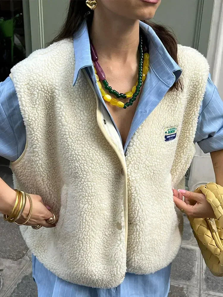 Women's oversized Sherpa fleece vest, plush high-pile texture, sleeveless layering piece for cozy seasonal warmth