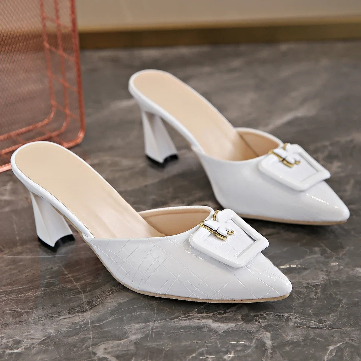 Women's vegan leather embossed mules with butterfly buckle accent, vintage-inspired slip-on style