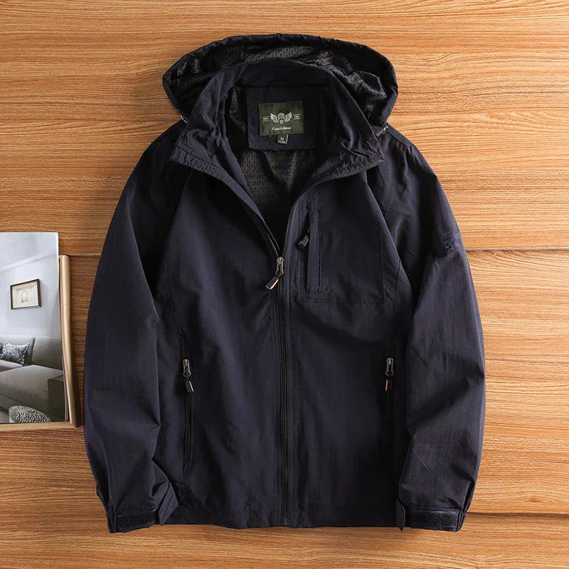 Men's hip-length hiking jacket in neutral tone, full-zip hooded design with secure zippered pockets