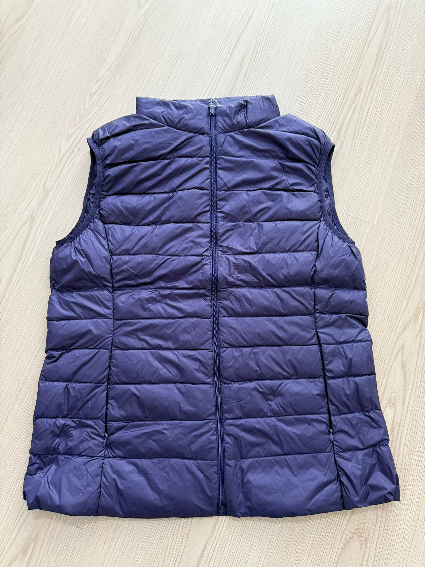 Women's cropped sleeveless down puffer vest lightweight nylon shell for layering and outdoor warmth
