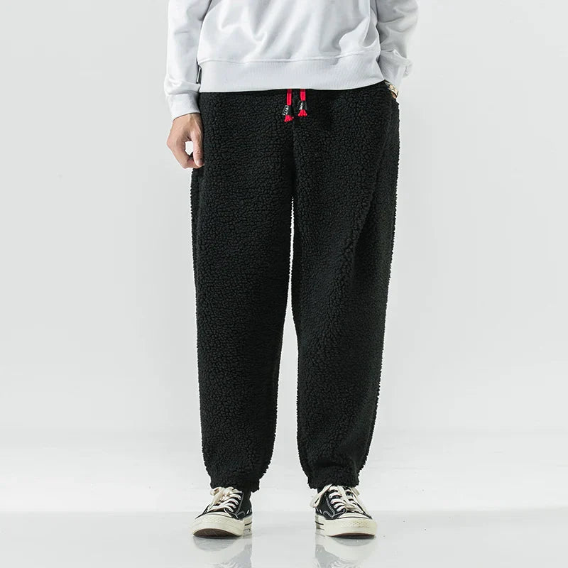 Men's slim tapered gray joggers with elastic waistband and side pockets for cool-weather comfort