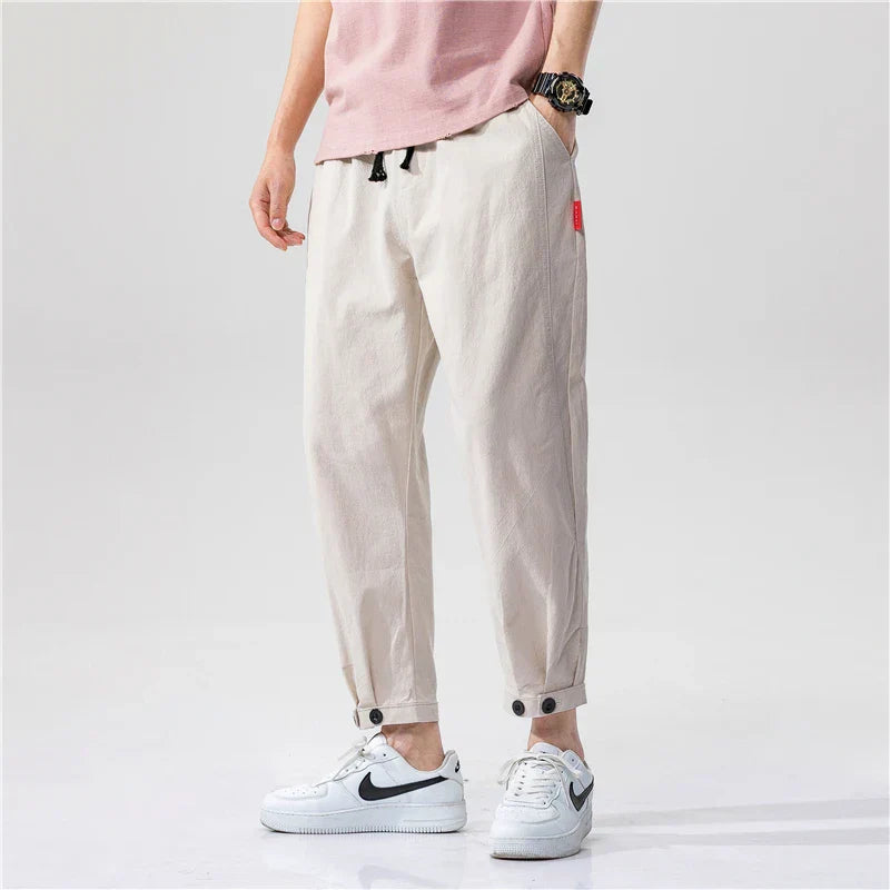 Beige relaxed cropped cotton pants with drawstring waist, tapered silhouette for casual wear
