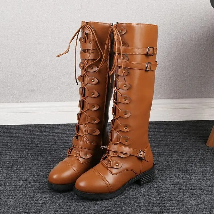 Women's brown leather knee-high lace-up boots with buckle detail and rugged sole structured fit