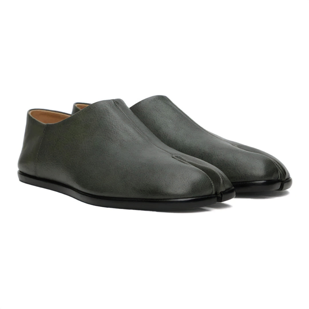 Black leather tabi loafers with split-toe silhouette, heritage craftsmanship meets modern urban style