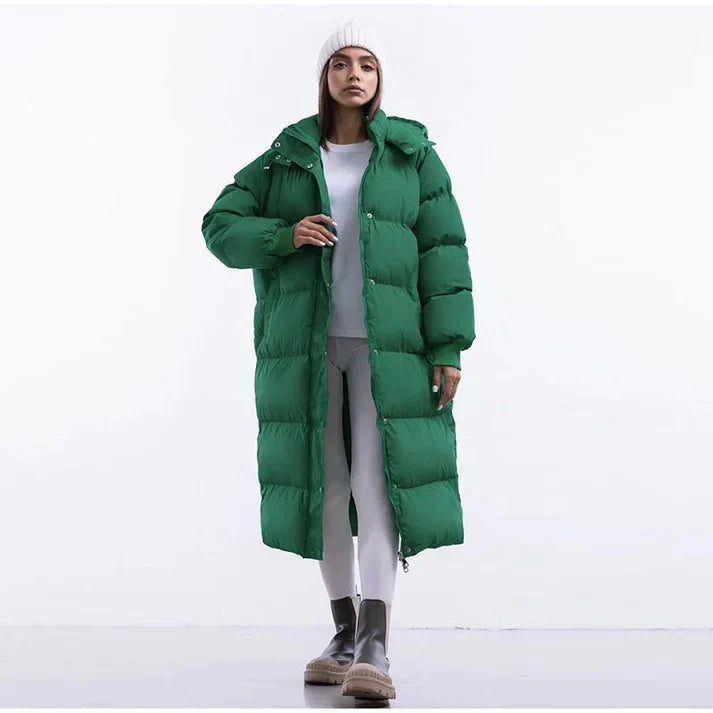 Women's long hooded puffer coat in neutral tone, full-length silhouette for cold weather warmth
