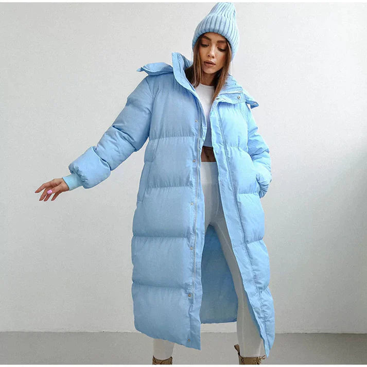 Women's long hooded puffer coat in neutral tone, full-length quilted winter style for cold weather