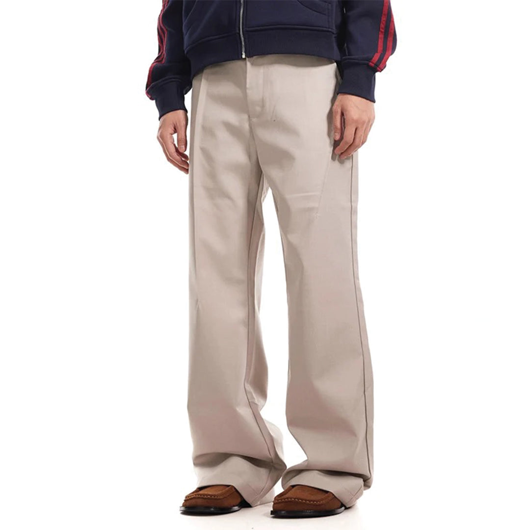 Navy blue flared trousers with pleated front, deconstructed tailoring, and vintage-inspired wide-leg cut