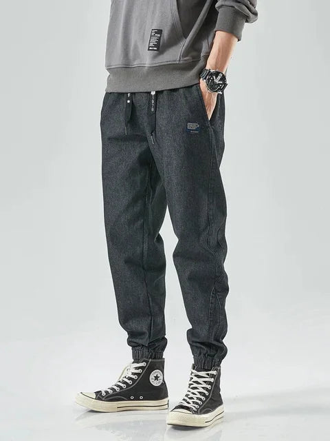 Men's urban denim jogger pants in classic blue with tapered fit and elastic waistband