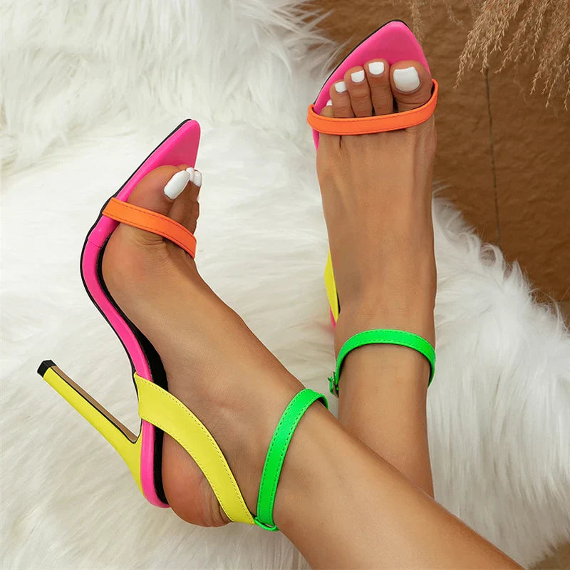 Neon stiletto heels with ankle strap buckle, bold high-contrast hues for nightlife fashion-forward women