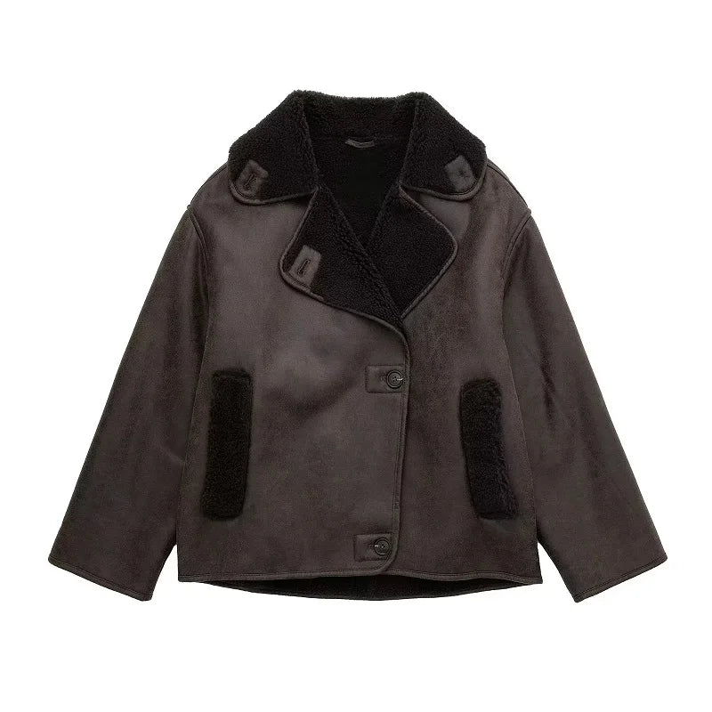 Women's brown shearling aviator jacket with plush fur lining, vintage-inspired style and bold silhouette