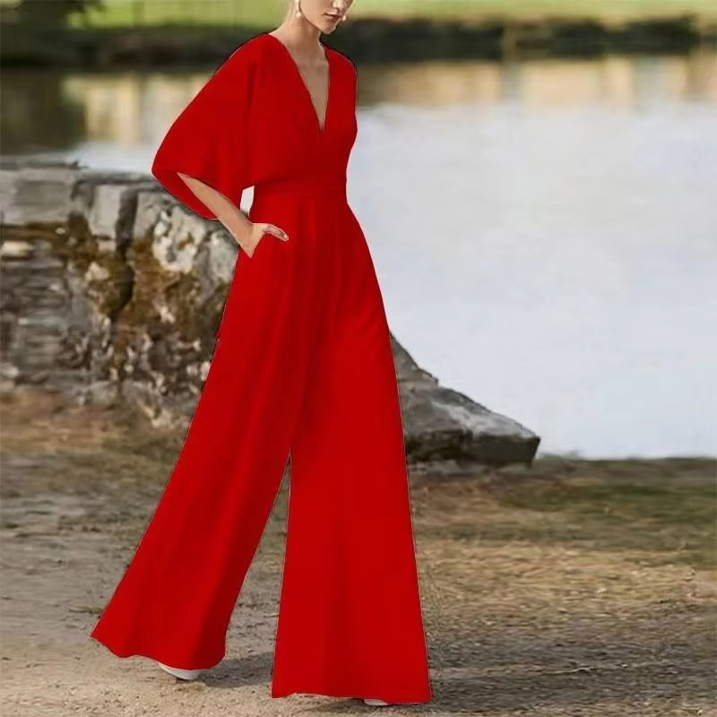 Women's solid color low waist long jumpsuit with wide-leg cut and sleek side button closure